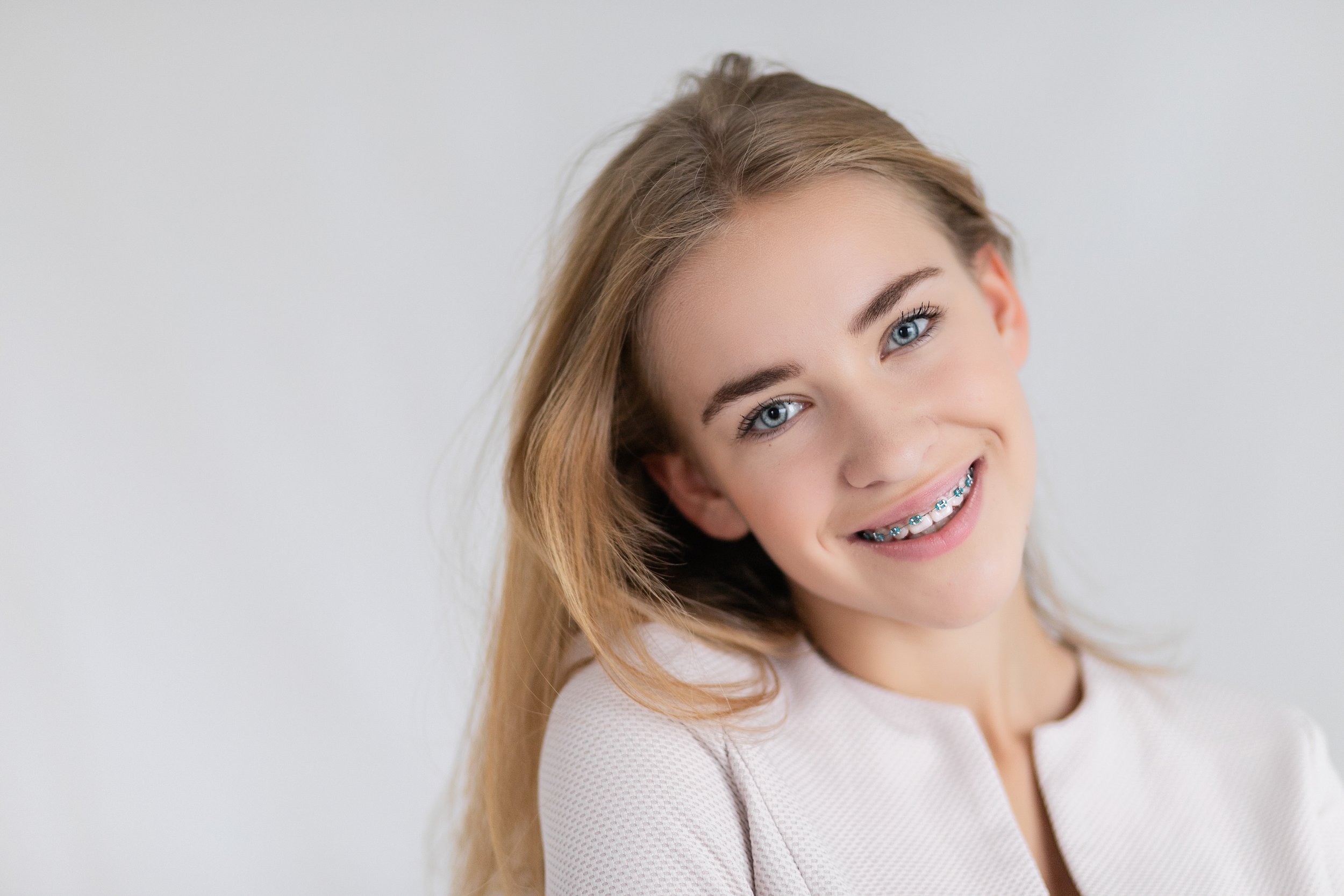 Smiling young woman wearing clear braces