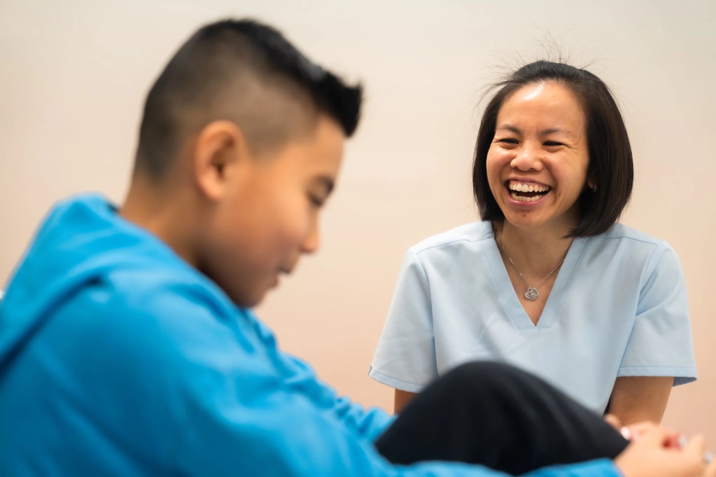 Dr. Shauna Fung laughing with a young patient during a check-up