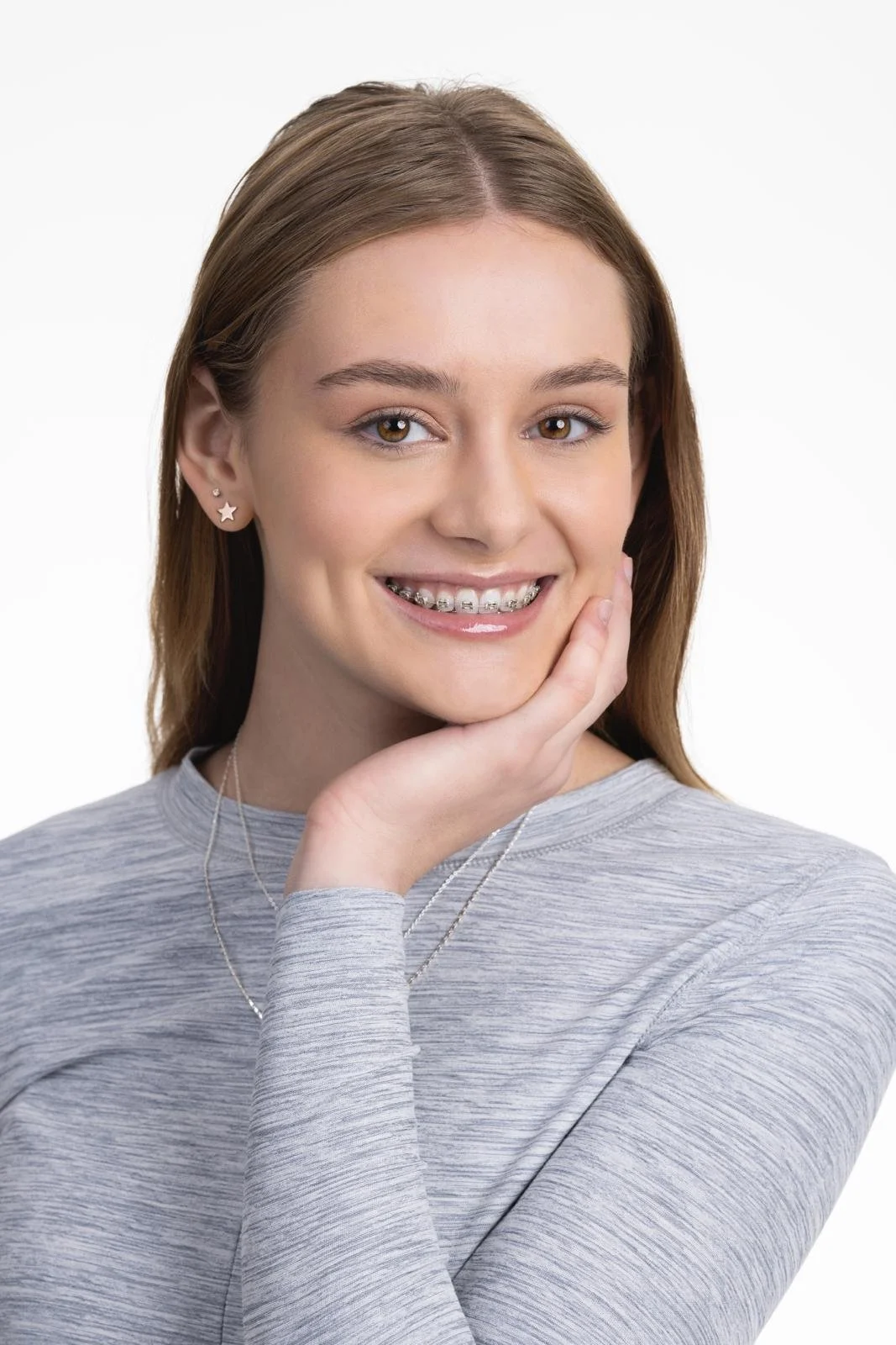 Smiling young woman wearing clear braces